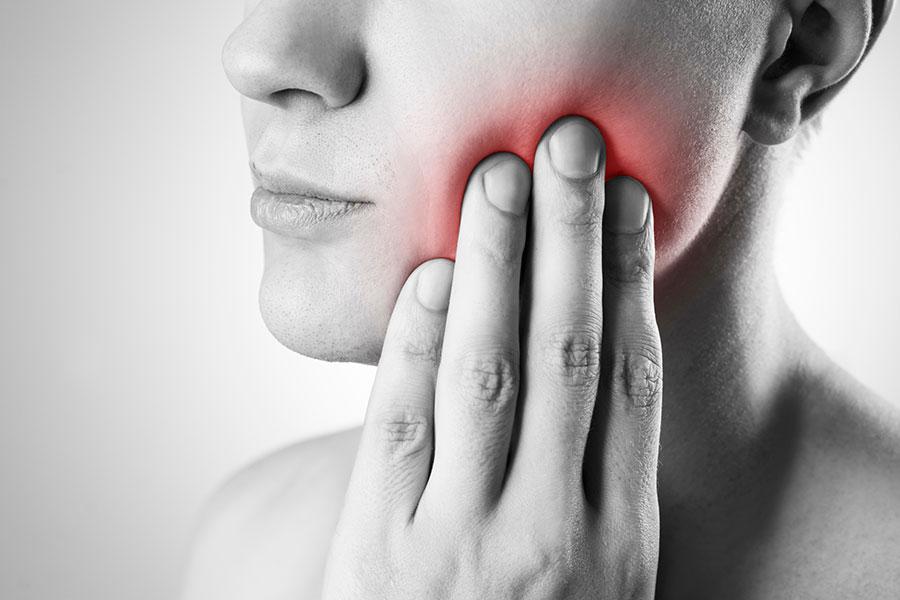 Woman experiencing pain from wisdom tooth